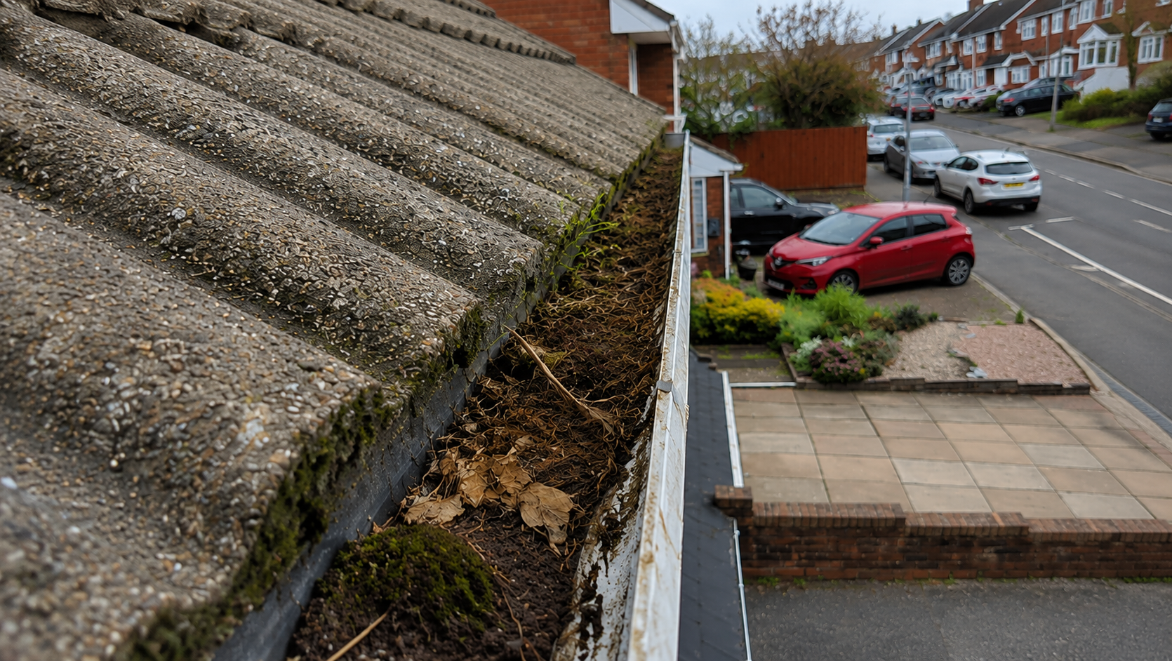 Before professional gutter cleaning Birmingham — full debris load blocking protective function